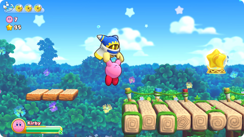 Magolor pulling Kirby up from falling into a pit.