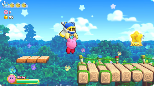 Magolor salvando o Kirby de cair em um buraco.